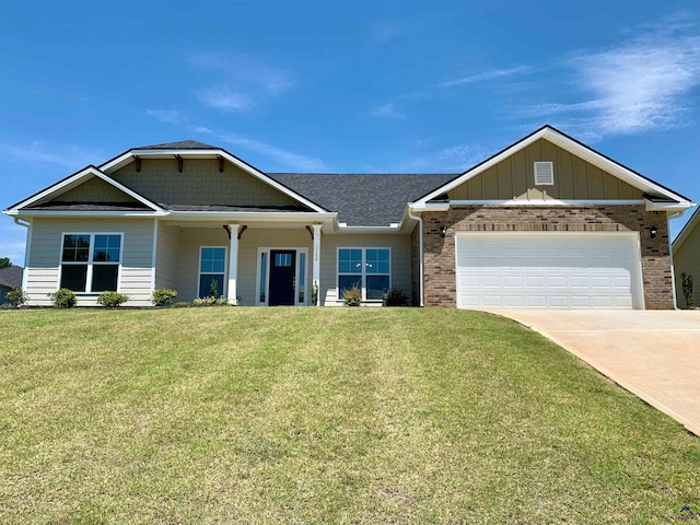 craftsman house with a garage and a front lawn