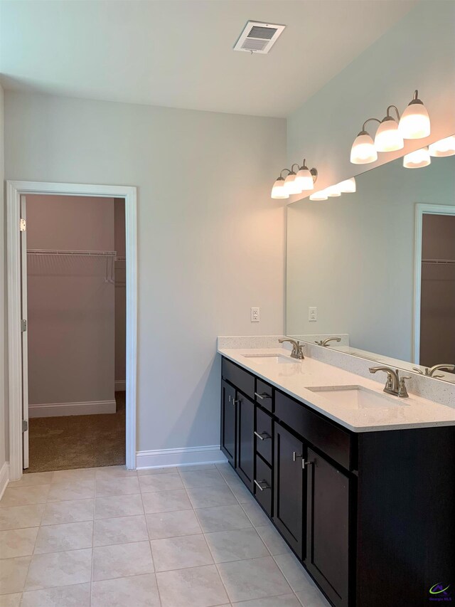 bathroom with tile patterned flooring and vanity