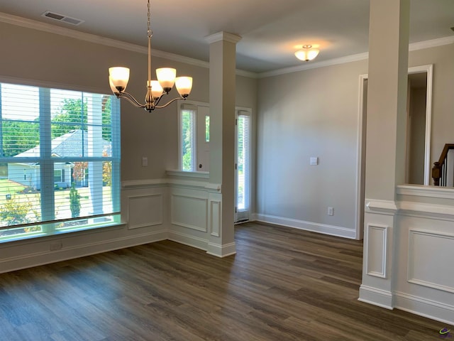 unfurnished dining area with crown molding, dark wood-type flooring, and an inviting chandelier