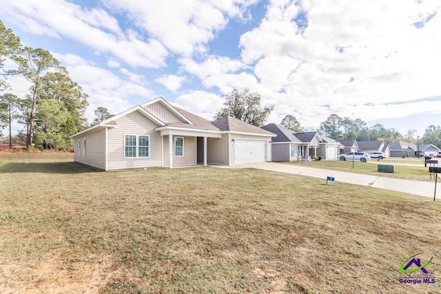 view of front of home with a front yard and a garage