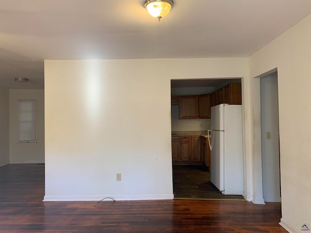 unfurnished room featuring dark wood-type flooring