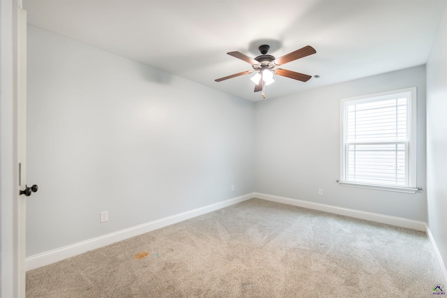 carpeted spare room with ceiling fan