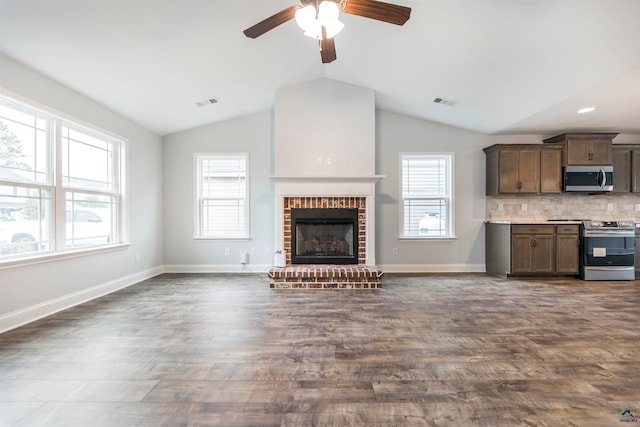 unfurnished living room with dark hardwood / wood-style floors, a brick fireplace, ceiling fan, and lofted ceiling