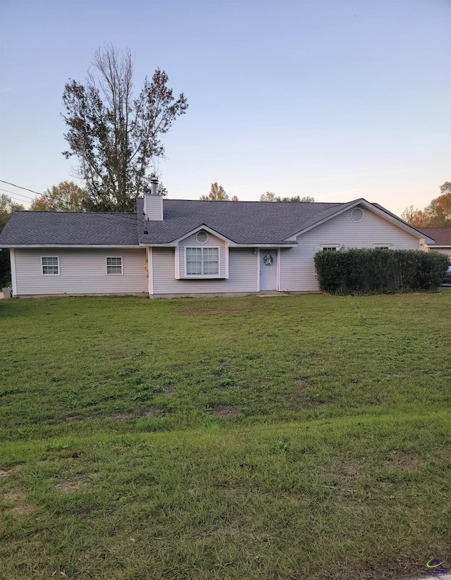 ranch-style house with a lawn