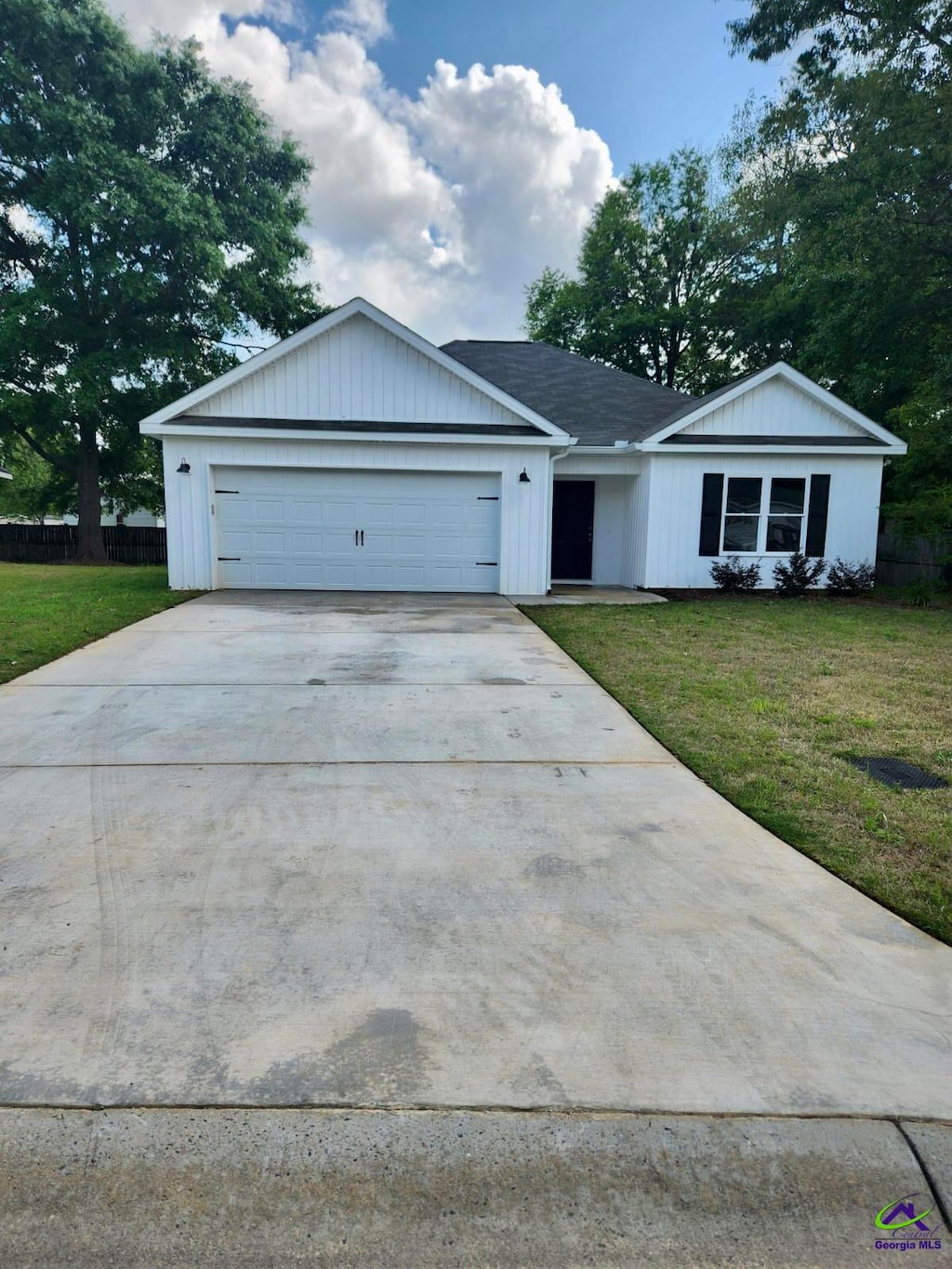 ranch-style house with a front lawn and a garage