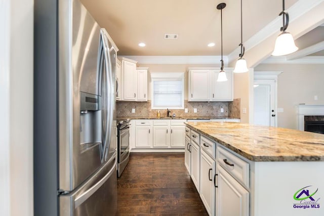 kitchen with light stone countertops, dark wood-type flooring, pendant lighting, white cabinets, and appliances with stainless steel finishes