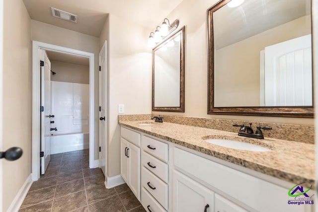 bathroom featuring vanity, tile patterned floors, and  shower combination