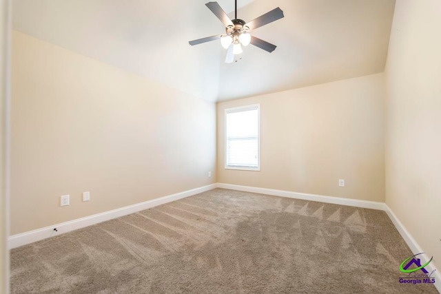 carpeted empty room featuring ceiling fan and vaulted ceiling