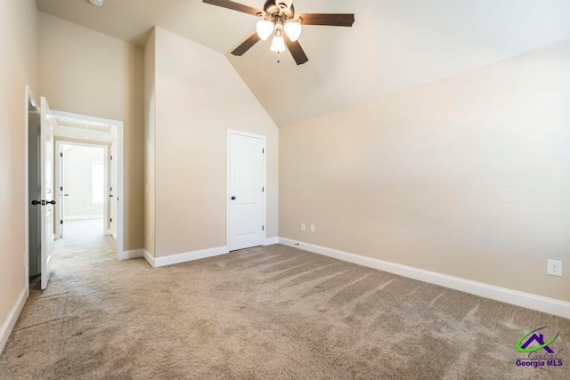 unfurnished bedroom featuring light carpet, high vaulted ceiling, and ceiling fan