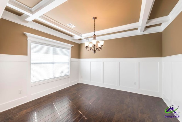 unfurnished room with beam ceiling, dark wood-type flooring, coffered ceiling, an inviting chandelier, and crown molding