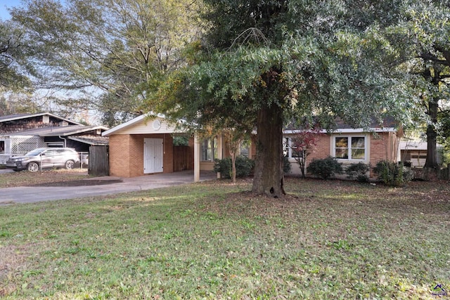 view of front facade with a front yard and a carport