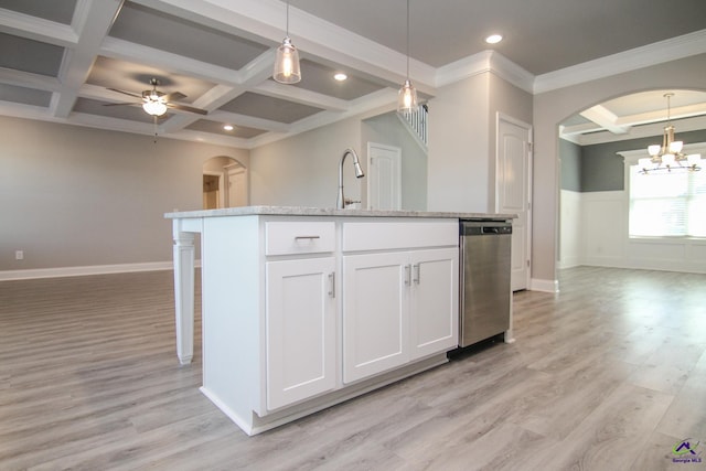 kitchen featuring stainless steel dishwasher, ceiling fan with notable chandelier, white cabinets, light hardwood / wood-style floors, and an island with sink