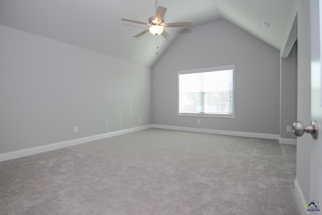 carpeted spare room with ceiling fan and lofted ceiling