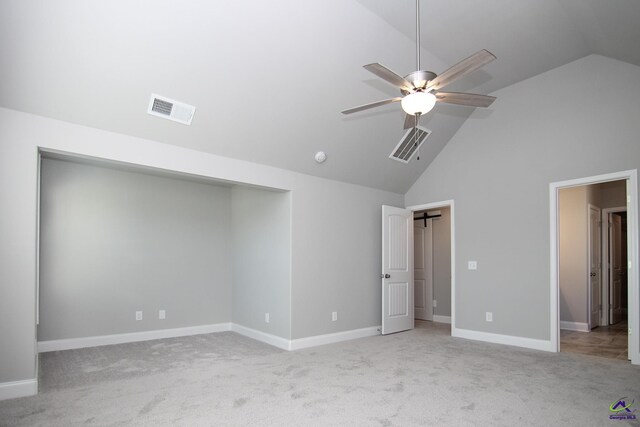 unfurnished bedroom featuring light colored carpet, high vaulted ceiling, and ceiling fan