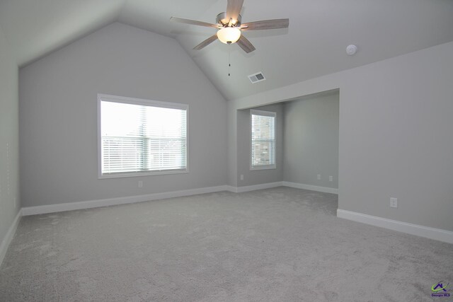 unfurnished room featuring ceiling fan, lofted ceiling, and light carpet