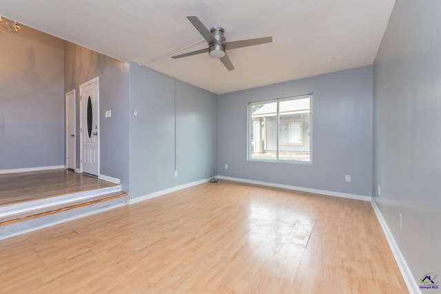 unfurnished room featuring light wood-type flooring and ceiling fan