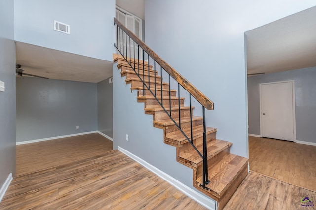 stairs with hardwood / wood-style floors