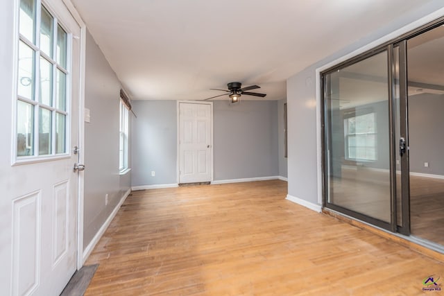 spare room featuring ceiling fan and light hardwood / wood-style flooring