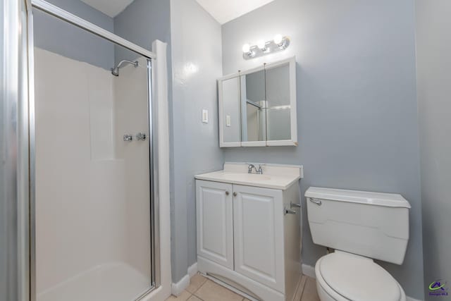 bathroom featuring tile patterned flooring, vanity, toilet, and a shower with door