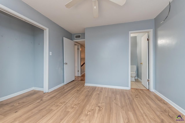 unfurnished bedroom featuring ceiling fan, light wood-type flooring, and connected bathroom