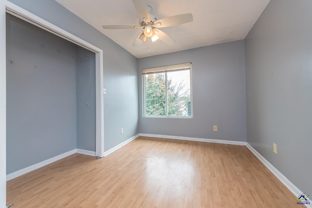 empty room with light wood-type flooring and ceiling fan