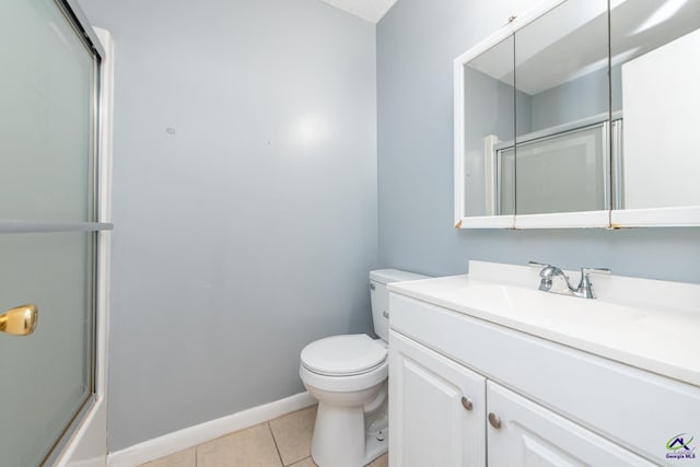 bathroom with tile patterned floors, vanity, and toilet