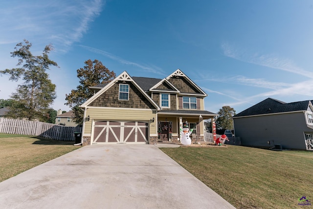 craftsman inspired home featuring a porch, a garage, and a front lawn