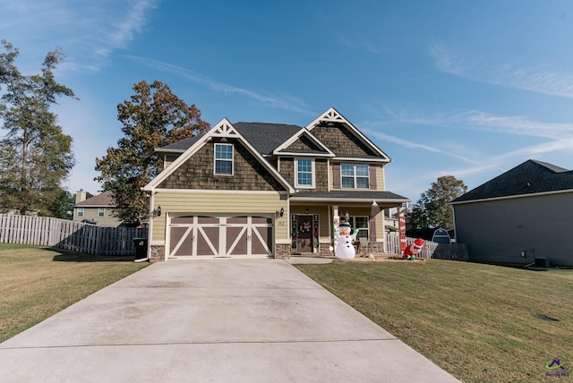 craftsman-style home featuring a front yard, a garage, and covered porch