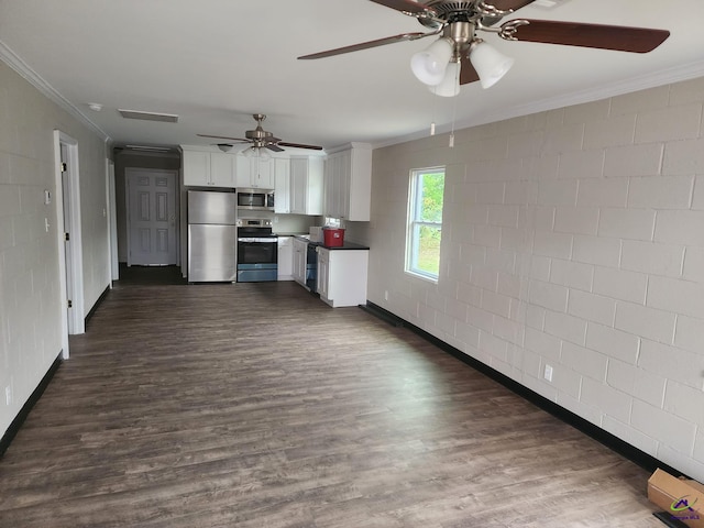 kitchen with ceiling fan, dark hardwood / wood-style flooring, appliances with stainless steel finishes, white cabinets, and ornamental molding