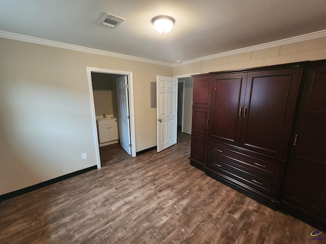 bedroom with wood-type flooring, ensuite bathroom, and ornamental molding