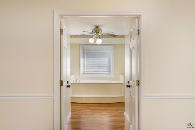 hallway with light hardwood / wood-style floors