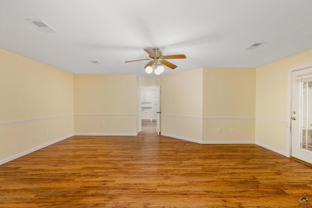 empty room with hardwood / wood-style flooring and ceiling fan