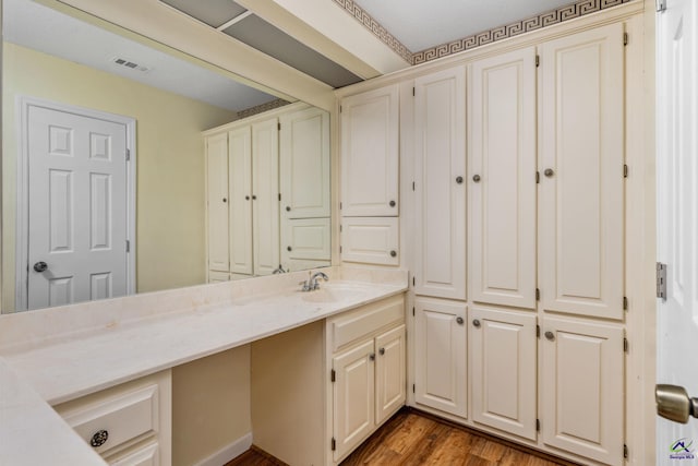 bathroom with hardwood / wood-style floors and vanity