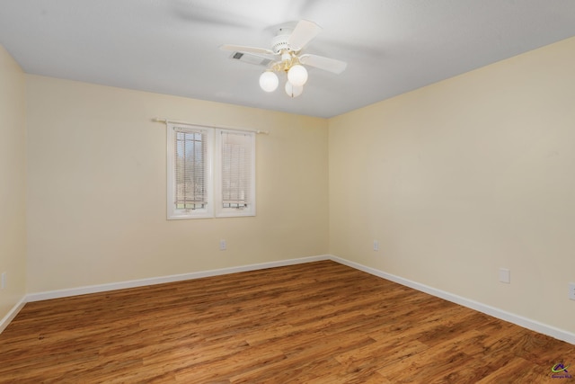 spare room with hardwood / wood-style flooring and ceiling fan