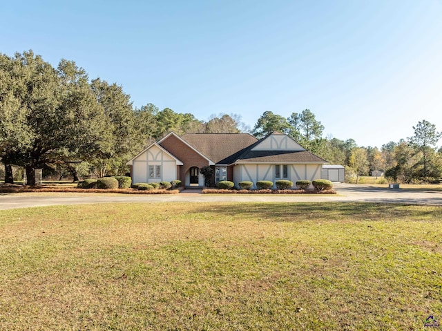 view of front of home featuring a garage and a front lawn