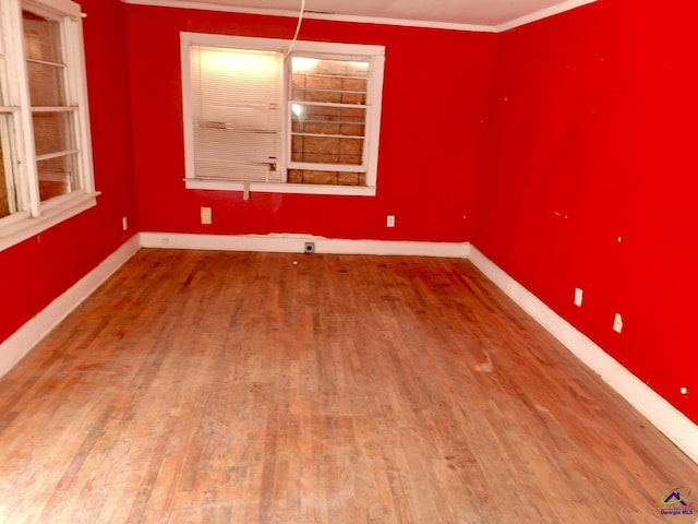 unfurnished dining area with crown molding and hardwood / wood-style floors