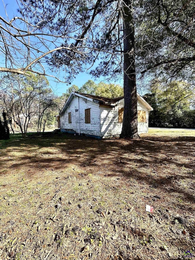 view of home's exterior with a lawn