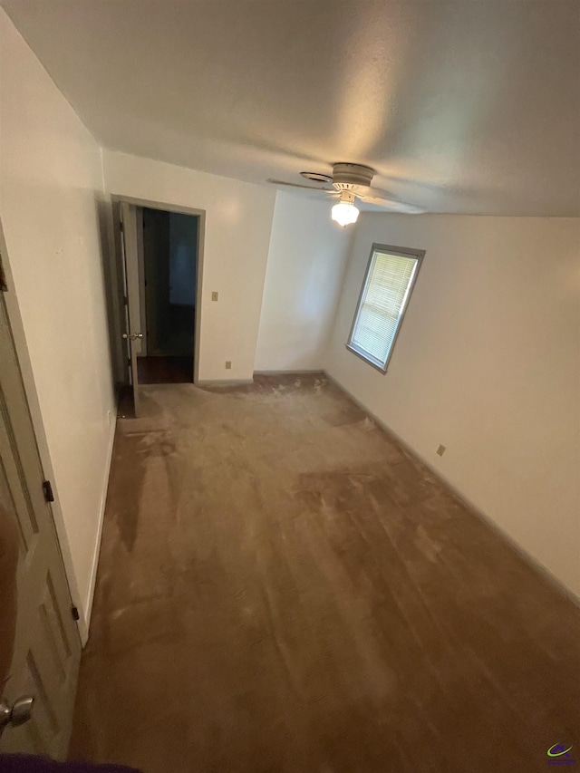 unfurnished bedroom with a ceiling fan and carpet