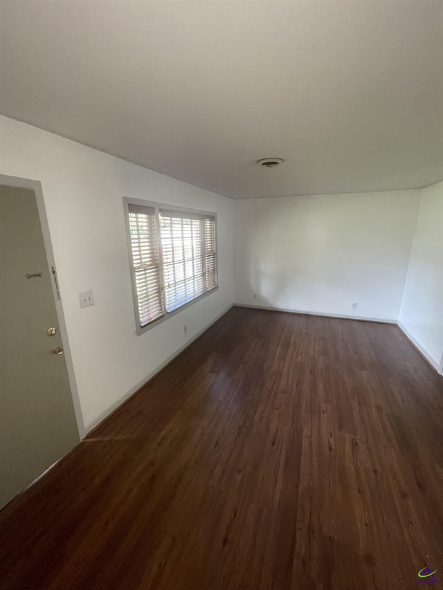 interior space featuring dark wood-style flooring and visible vents