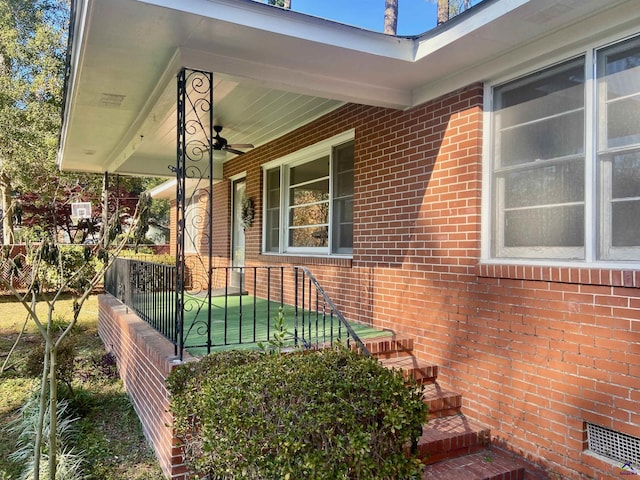 exterior space featuring fence, a ceiling fan, a porch, crawl space, and brick siding