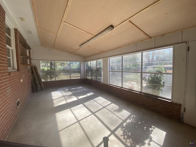 unfurnished sunroom with lofted ceiling and a healthy amount of sunlight