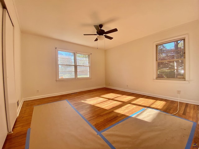 empty room featuring hardwood / wood-style flooring and ceiling fan