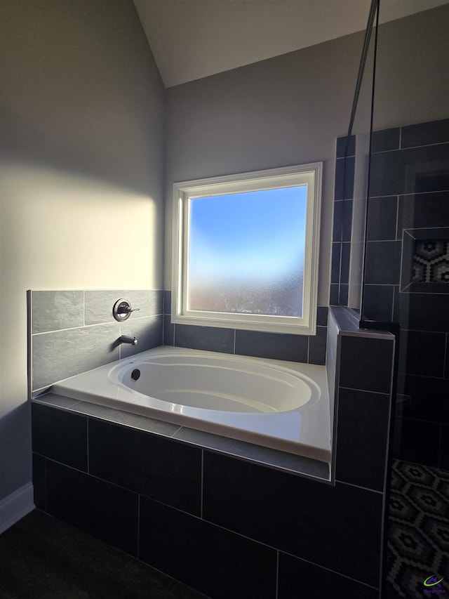 bathroom with plus walk in shower and vaulted ceiling