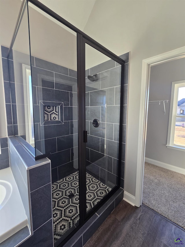 bathroom with a tile shower, vanity, and hardwood / wood-style flooring