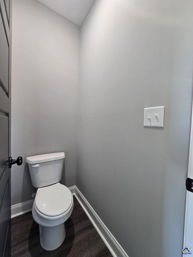 bathroom with wood-type flooring and toilet