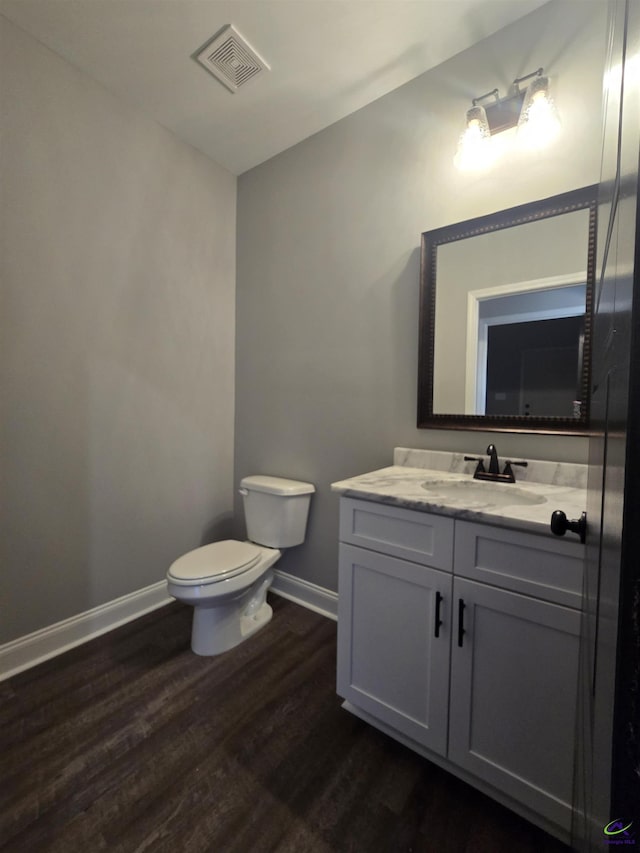 bathroom featuring hardwood / wood-style floors, vanity, and toilet