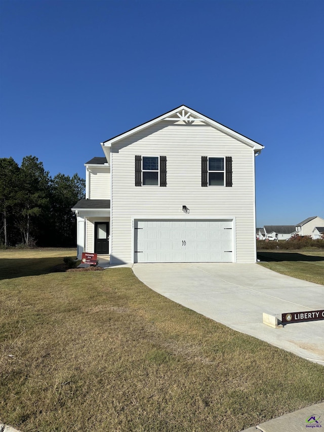 view of front of home with a garage and a front lawn