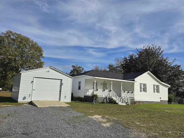 view of front of home featuring a porch, a garage, a front lawn, and an outdoor structure