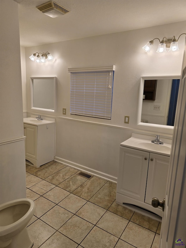 bathroom featuring tile patterned flooring and vanity