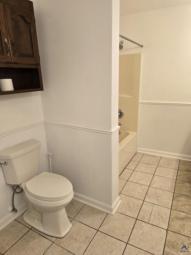 bathroom with tile patterned floors, toilet, and bathing tub / shower combination